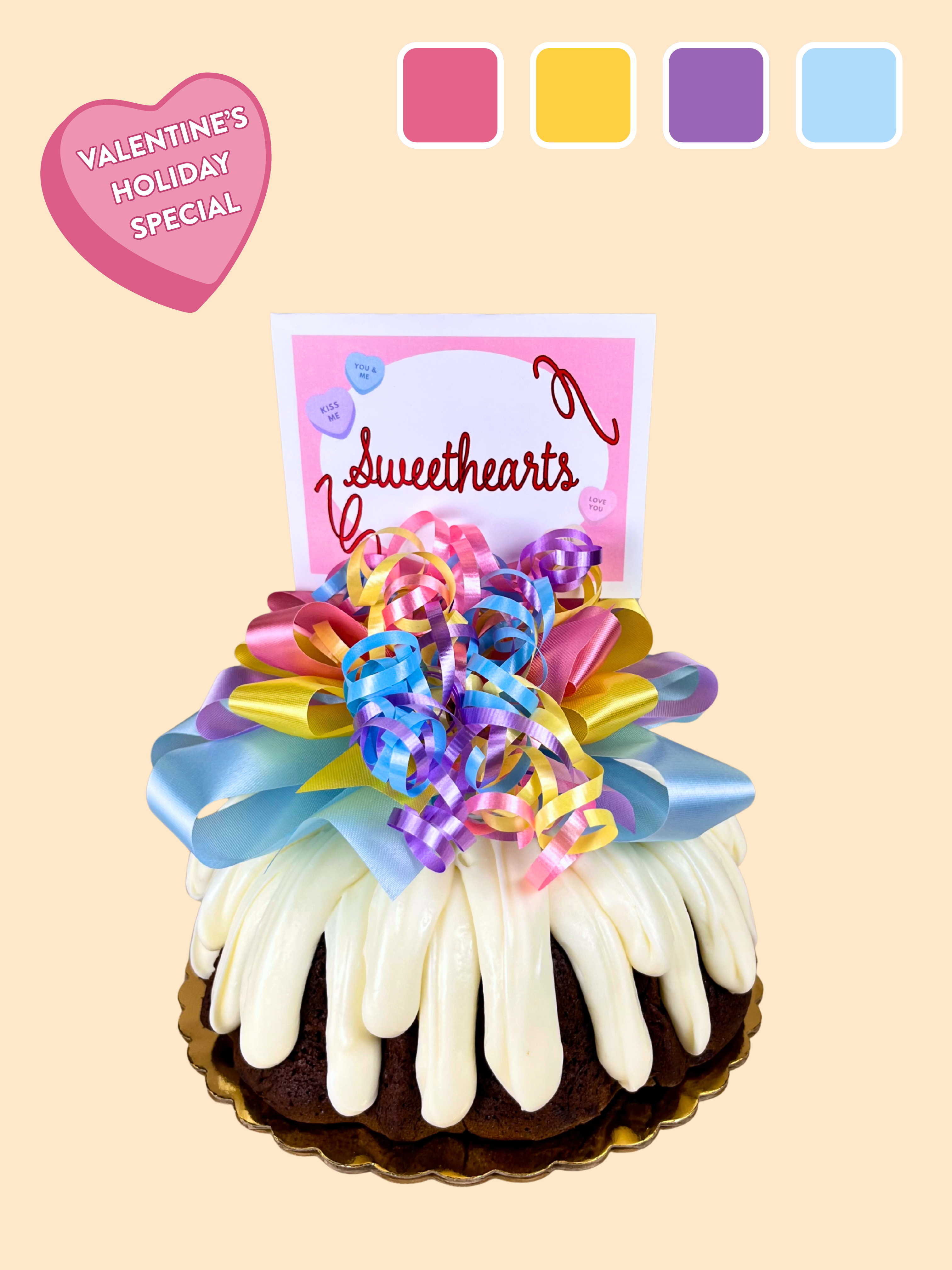 A cake with cream cheese frosting decorated with pastel valentine's day colors with a sweetheart topper.