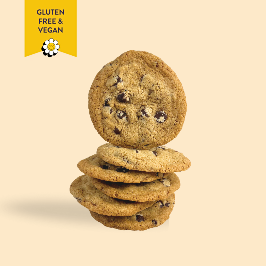 Stack of gluten-free and vegan chocolate chip cookies on a beige background with a yellow label.