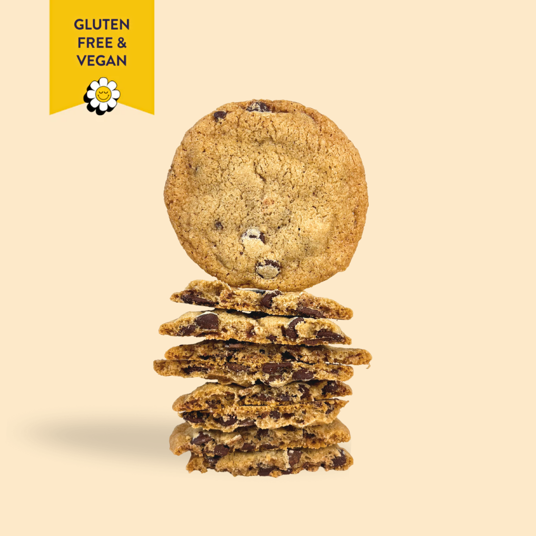 Stack of gluten-free and vegan cookies with a yellow label on a beige background