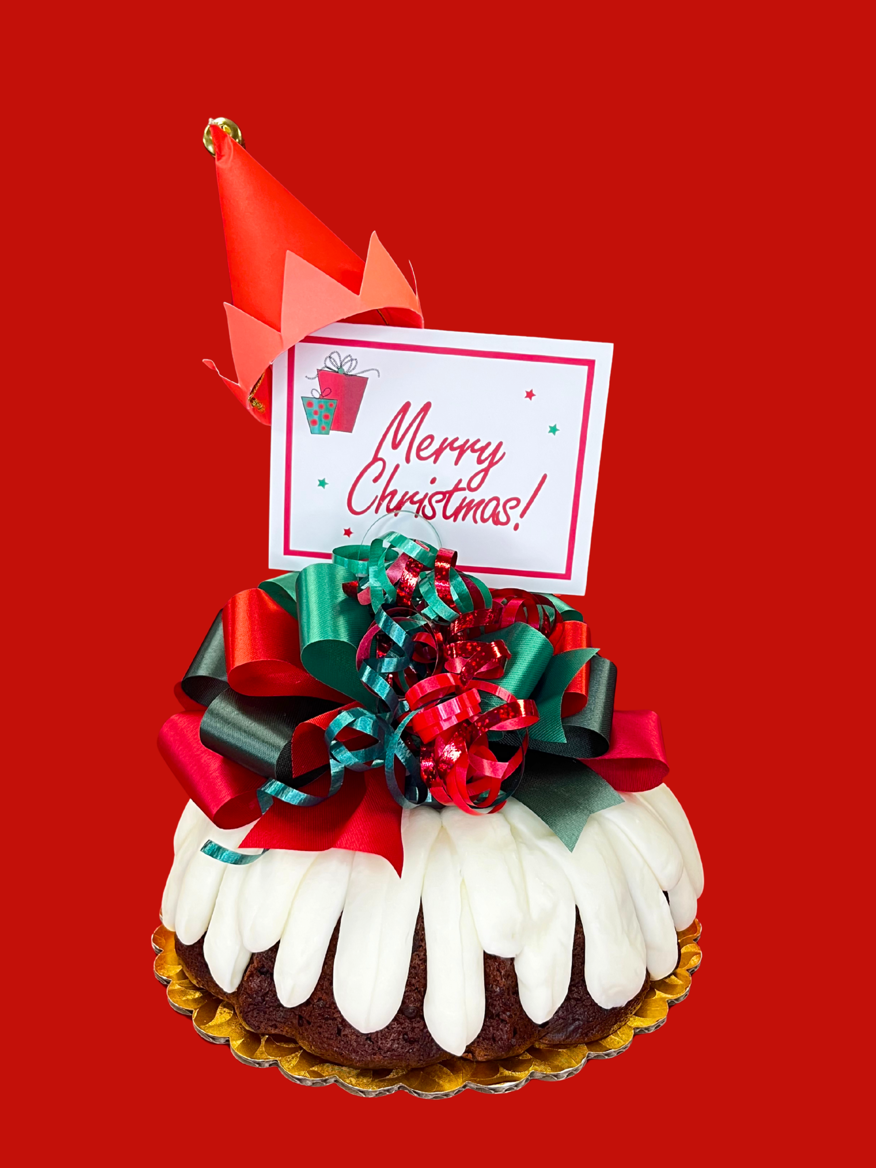 Elf Hat on a Bundt decoration on a bundt cake with a decorative bow and personalized sign on a red background