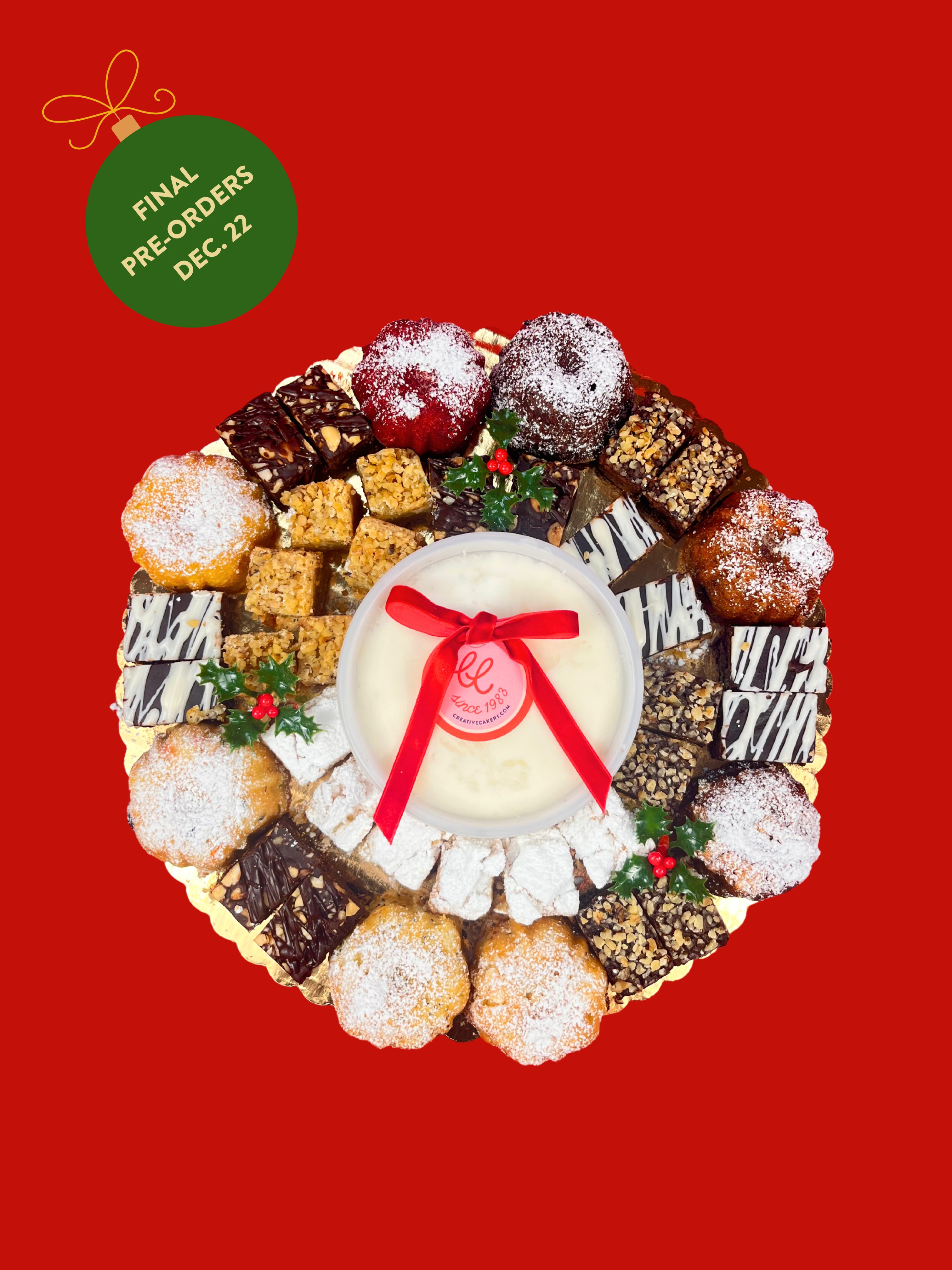 Assorted dessert wreath with a central round item on a red background, featuring a green label with text.